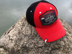 Rock & Shackle Crawler Cap, Backwoods, Series 1. Red front, black back structured snap back cap. Custom removable patch with hook and loop attachment. Top button free for comfort with ear protection and headphones. Lucky Shackle included.