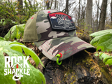 Camo structured snapback cap, made of high quality fabrics and loaded with features. The extra large hook and loop patch system allows for mounting of your favorite morale patches, from standard 2x3" flag style to our signature Rock & Shackle Pioneer Sunset hexagon top patch. If you want to drop the top patch, the lower loops are embroidered with the Rock & Shackle emblem. Crawler Caps are top button free to make wearing your favorite ear protection or headsets pain free. Lucky Shackle included.