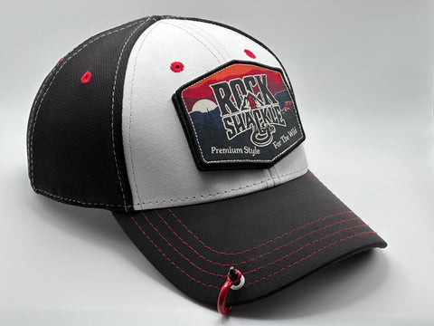 Rock & Shackle Birchline snapback cap, white front black back with red accents. 